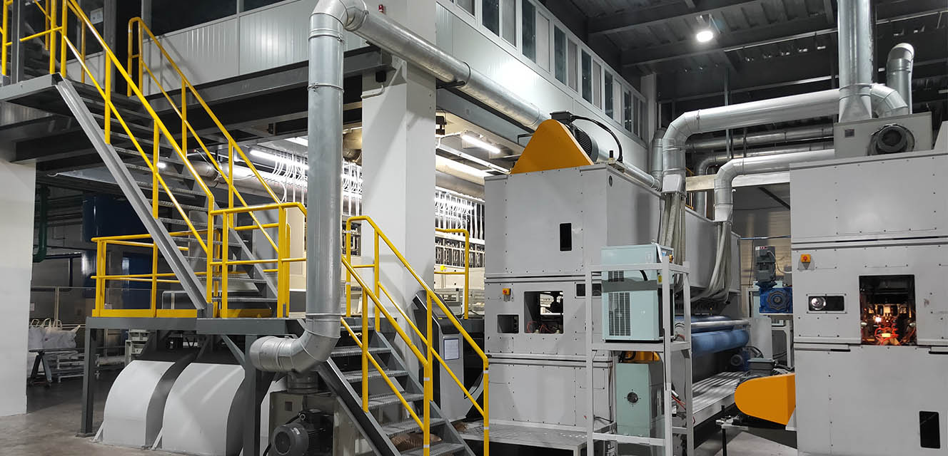 Interior of Trias Spunindo Industri factory showing nonwoven manufacturing machinery